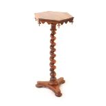 An early 19th Century yew wood occasional table, the hexagonal top over a shaped frieze with down