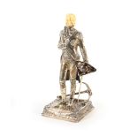 A continental silver figure of Lord Nelson, with carved ivory head, standing holding his tricorn hat