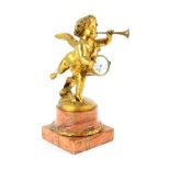 A late 19th century French gilt bronze figure of a winged cherub standing on one foot, blowing a