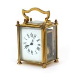 An early 20th Century carriage style timepiece, enamel dial, brass and glass case, eight-day