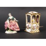 A Meissen style figure of a lady in a floral decorated Sedan chair with brass lifting handles, 13.