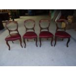 A set of four Victorian mahogany frame Dining Chairs with scroll carved cresting rails, pierced