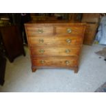 A George III mahogany Chest of three long and two short graduated Drawers with brass handles and