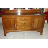 An early 20th Century oak Sideboard with raised back, above three centre drawers, flanked by pair of