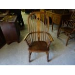A Victorian beech and elm Windsor high back Elbow Chair with pierced splat paneled seat and turned