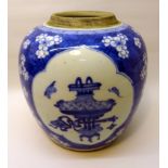A Chinese Ginger Jar decorated with vases etc in blue and white on a prunus pattern ground. 8 1/