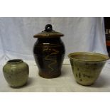 A Slip ware Studio Pottery lidded jar and two studio pottery vases.