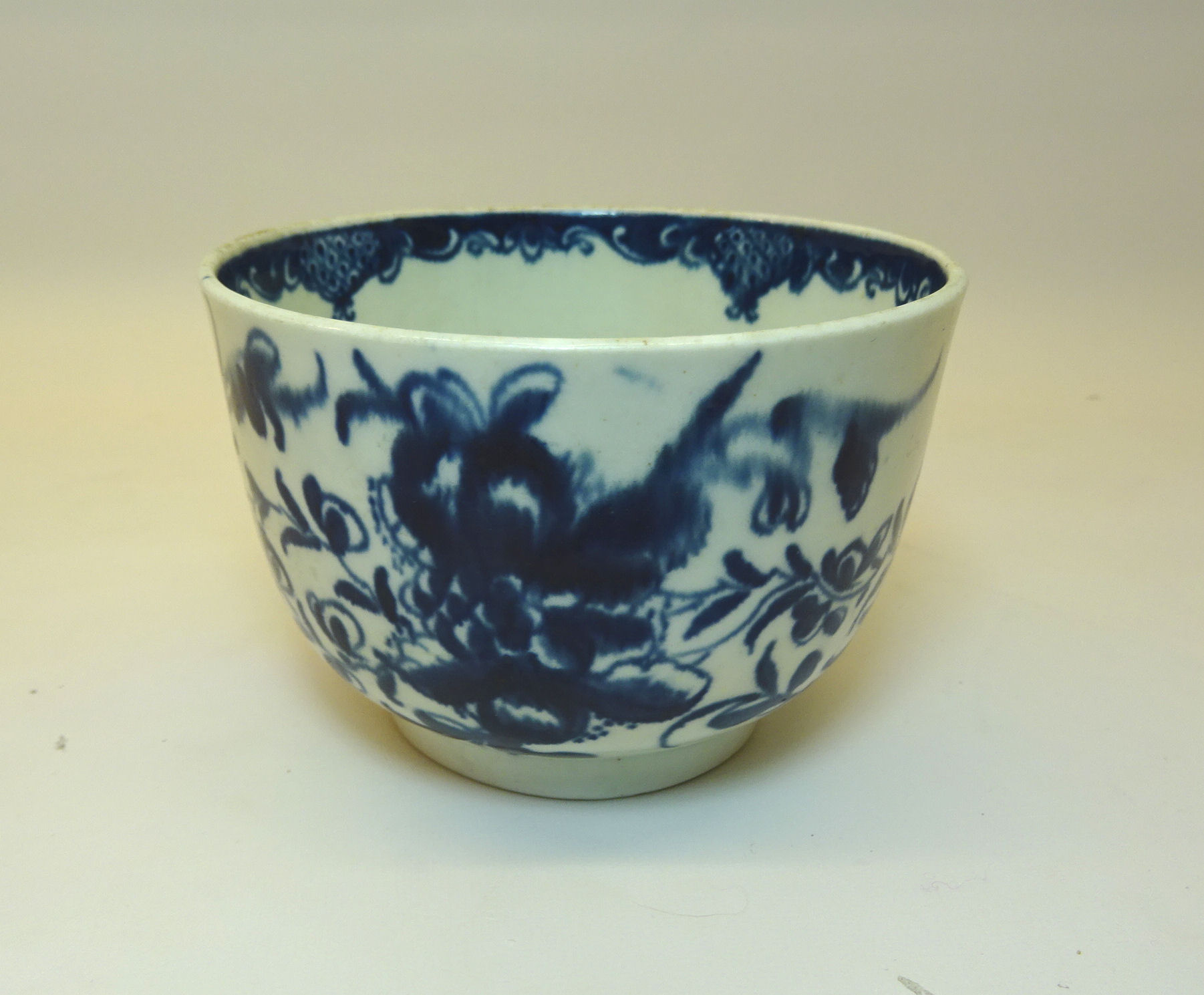 An 18th Century Worcester first period circular Bowl decorated with flowers in blue and white and