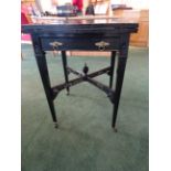 An Edwardian ebonised envelope top Card Table, the baize lined interior with counter wells, a single