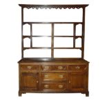 An 18th Century oak Dresser Base fitted with three frieze drawers, with further drawers and