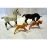 A Beswick Model of large shire foal in grey gloss, No. 951, a large brown foal, No. 947 and two