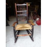 A 19th Century spindle back Rocking Elbow Chair with rush seat.