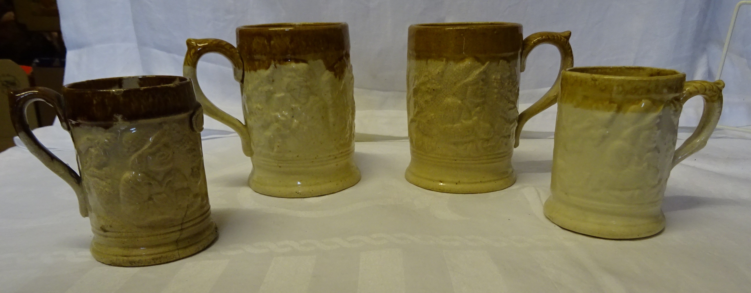 A pair of Victorian pottery Mugs depicting the murderer Charlie Peace decorated in relief and with