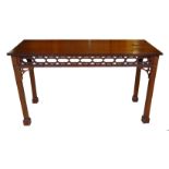 A Chippendale design mahogany Serving Table with reeded edge, carved pierced frieze on column square