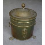 A brass cylindrical Coal Bucket with metal liner, ring handles and paw feet.