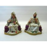 A pair of 19th Century Continental porcelain seated Figures of Middle Eastern male and female