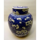 A large Chinese Ginger Jar and cover decorated in blue and white with prunus. 9 1/2" (24cms) high.