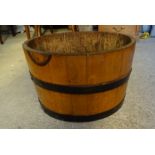 An oak and metal banded Barrel Log Bin. 19" (48cms) diameter.