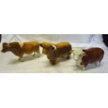 A Beswick Model of a Guernsey bull in gloss finish No. 1451 (ear chipped), a Hereford bull (ear