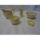 A Belleek shell shape Jug on shell feet, similar bowl and three other pieces of Belleek.