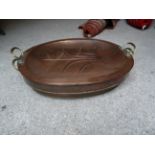 A large Victorian oval copper two handled Cooking Pan and lid. 25" (64cms) wide.