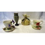 A Crown Devon Vase in the form of a tied bag, a Franz teacup and saucer decorated with flowers,