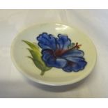 A Moorcroft circular Pin Dish decorated with Hibiscus on a white ground and with paper label to