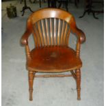 A Victorian beech and elm tub shape rail back Desk Chair with panelled seat on ring turned supports.