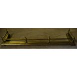 A brass oblong Fire Curb of urn and rail design. 4' 4" (132cms) wide.