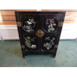 A small 20th Century Chinese black lacquer Cabinet with applied and painted floral decoration and