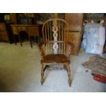 A Victorian beech and elm Windsor high back Elbow Chair with pierced splat panelled seat and