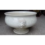 A late Victorian white glazed pedestal Jardiniere with lion mask handles. 13 1/2" (35cms) diameter.