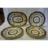 A pair of early 19th Century Davenport plates decorated with flowers in red, blue, green etc, within