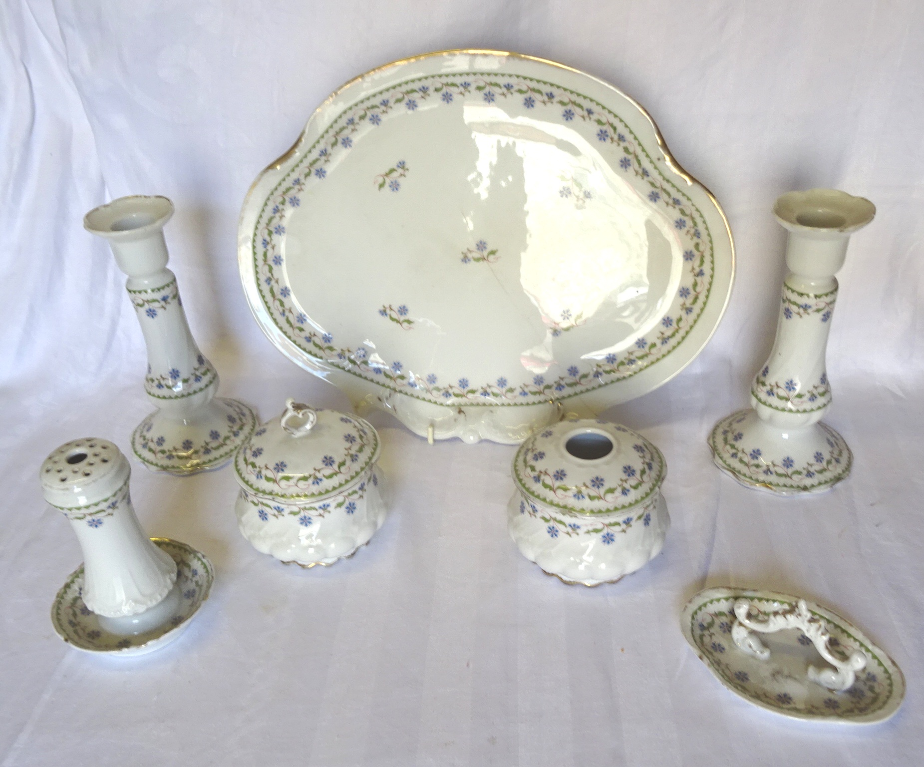 A Limoges seven piece Dressing Table Set comprising tray, covered jars, ring tree, hat pin holder