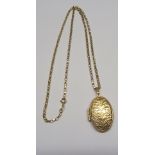 An engraved gold oval Locket on a 9ct gold Neck Chain.