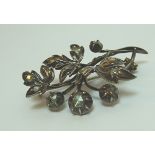 A silver spray Brooch, the flower heads and leaves set with thirteen old cut diamonds.