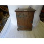 A small oak Cupboard, the interior fitted with two drawers and enclosed by panelled door with