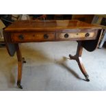 A Regency rosewood Sofa Table with 'D' shape drop end flaps, crossbanded border and two frieze