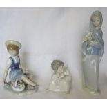 A Lladro Figure of a girl seated holding flowers, a Lladro Standing Figure of a girl holding