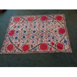 Another Wall Hanging with an all over floral pattern in blue, green, red, etc, on a beige field,