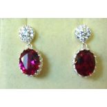 A pair of silver Pendant Earrings set with red crystals and cubic zirconia.