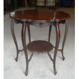 An early 20th Century mahogany circular two tier Occasional Table of serpentine outline on shaped