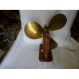 A ships brass Propeller mounted on a wooden stand and inscribed "Turtle".