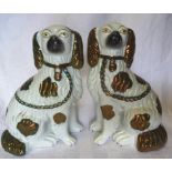 A pair of Staffordshire King Charles Spaniel Mantel Ornaments with divided front legs and copper