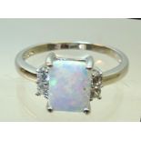 A silver Dress Ring set with square opal and cubic zirconia.