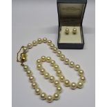 A matched Cultured Pearl Necklace, each 9 to 9.5mm with an 18ct. diamond set clasp, and a pair of