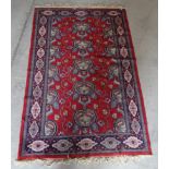 A central Asian Rug of stylised floral design on a red field and bordered. 6' 2" (188cms) x 4' 1" (