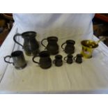 Seven Victorian pewter graduated baluster Measures and a brass pestle and mortar inscribed '1761'.