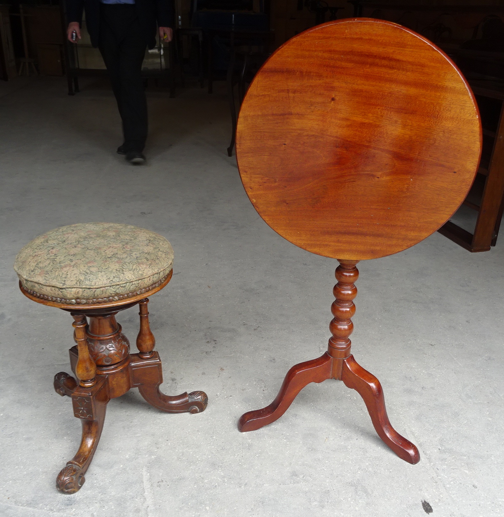 A Victorian walnut Piano Stool with circular top on turned cluster column and triple splay