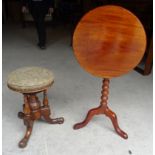 A Victorian walnut Piano Stool with circular top on turned cluster column and triple splay